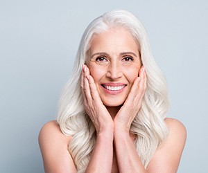 An older woman happy with her all-on-4 implants