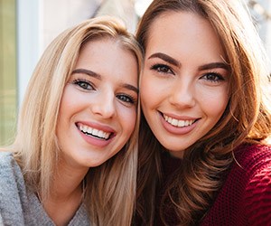 Two young women with beautiful smiles