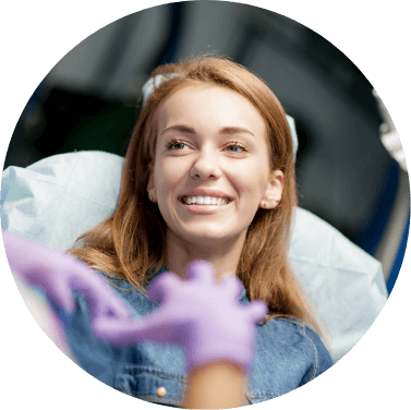 Woman smiling at dentist wearing gloves