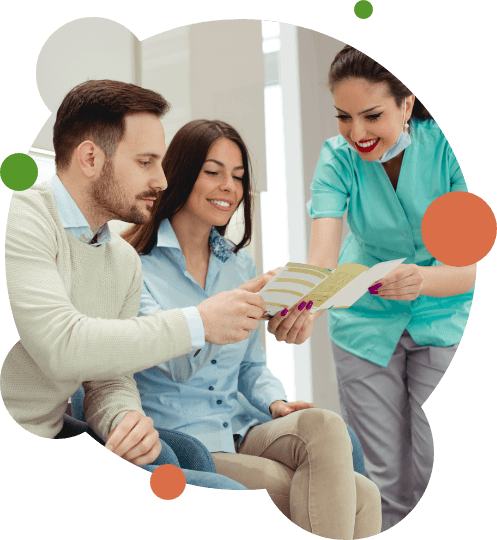 Dental team member showing brochure to patients