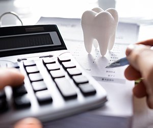 A patient calculating the cost of dental crowns