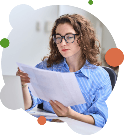 Woman with glasses looking at piece of paper