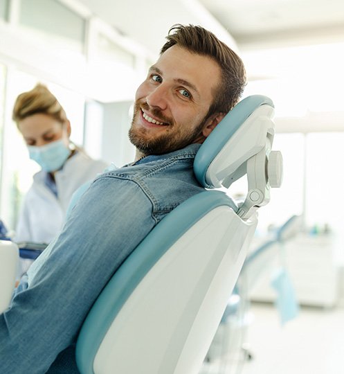 Patient smiling while sitting in treatment chair