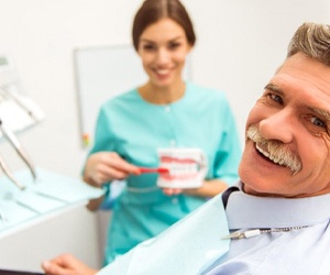 senior man at a consultation with his implant dentist in Plano, TX