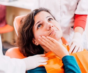 Woman with a toothache at the dentist