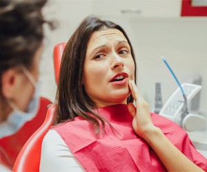 Woman at the dentist with a toothache 