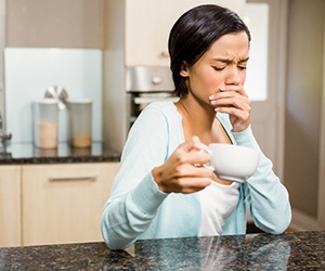 woman coffee toothache for root canal therapy in Plano