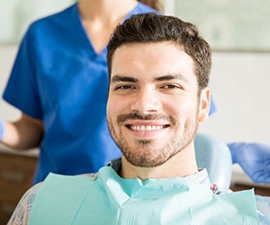 Bearded man sitting and smiling in dental chair