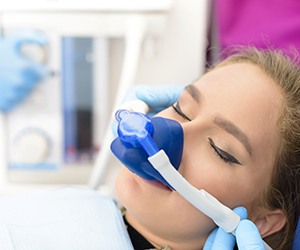 Woman relaxing with nitrous oxide dental sedation in Plano