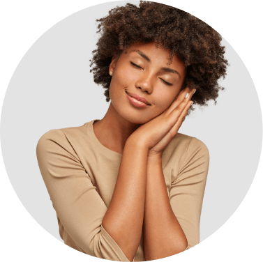Woman in light brown shirt sleeping on her hands