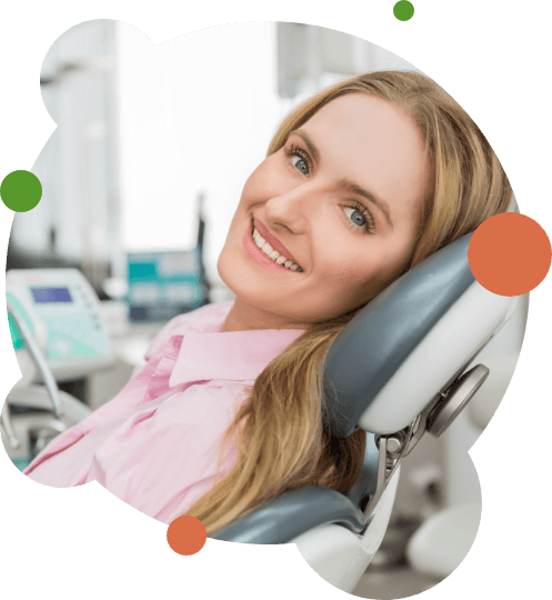 Blonde female dental patient smiling in dental chair