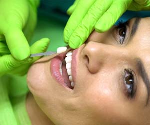 Woman having veneers in Plano placed by her dentist