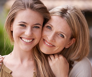 Mother and daughter smiling together