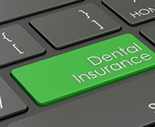 Dental insurance key on computer keyboard