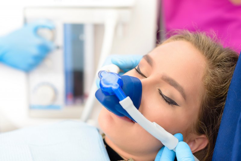 A woman receiving dental sedation