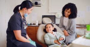 Dentist talking to child and parent.