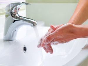 A person washing their hands.