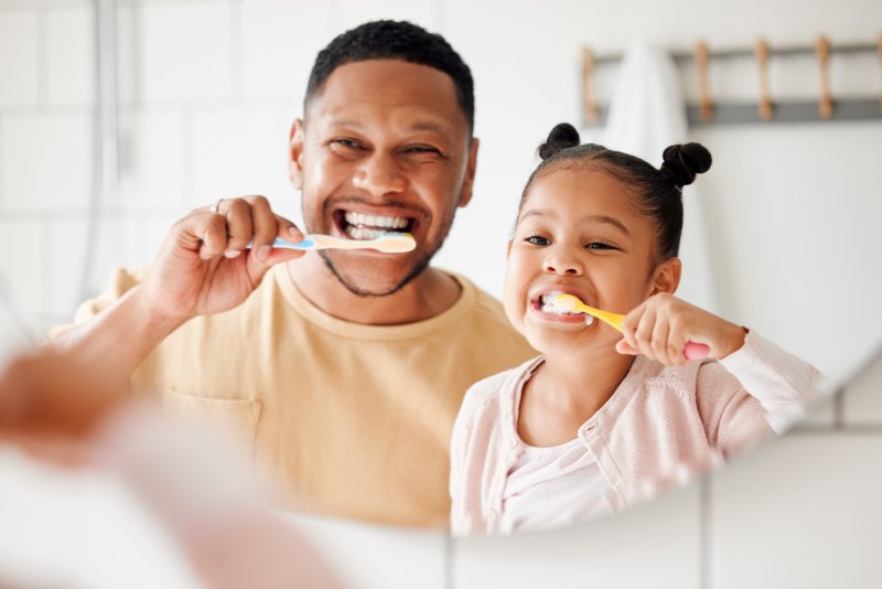 Parent and child brushing during Children’s Dental Health Month