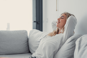 Woman at home resting on her couch