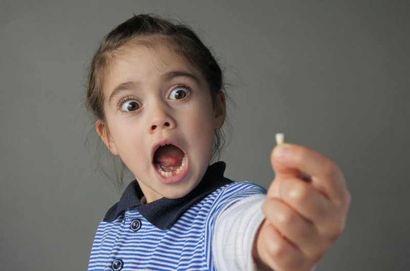 Child holding tooth