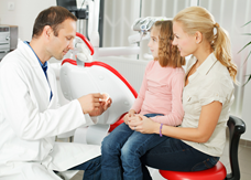 Young girl and mother at dentist