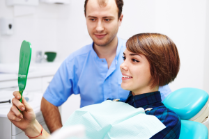 a patient smiling while visiting their dentist