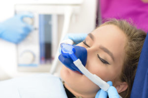 Woman wearing dental sedation mask